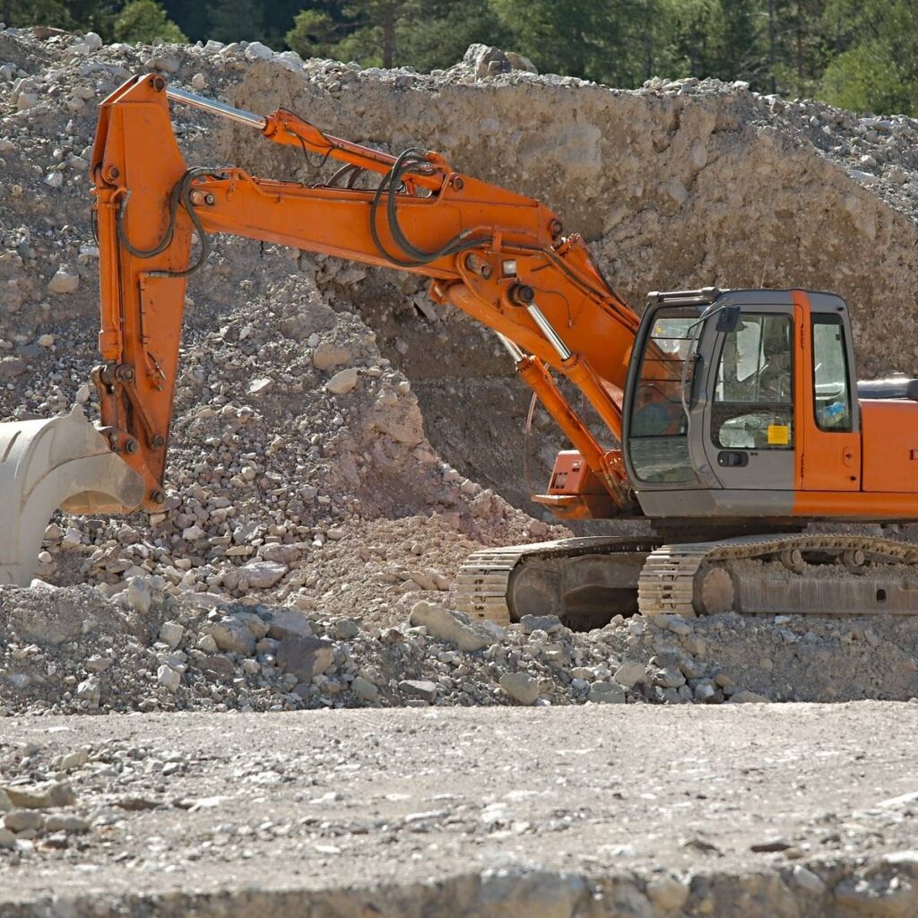 Excavator working in rock and dirt for site preparation