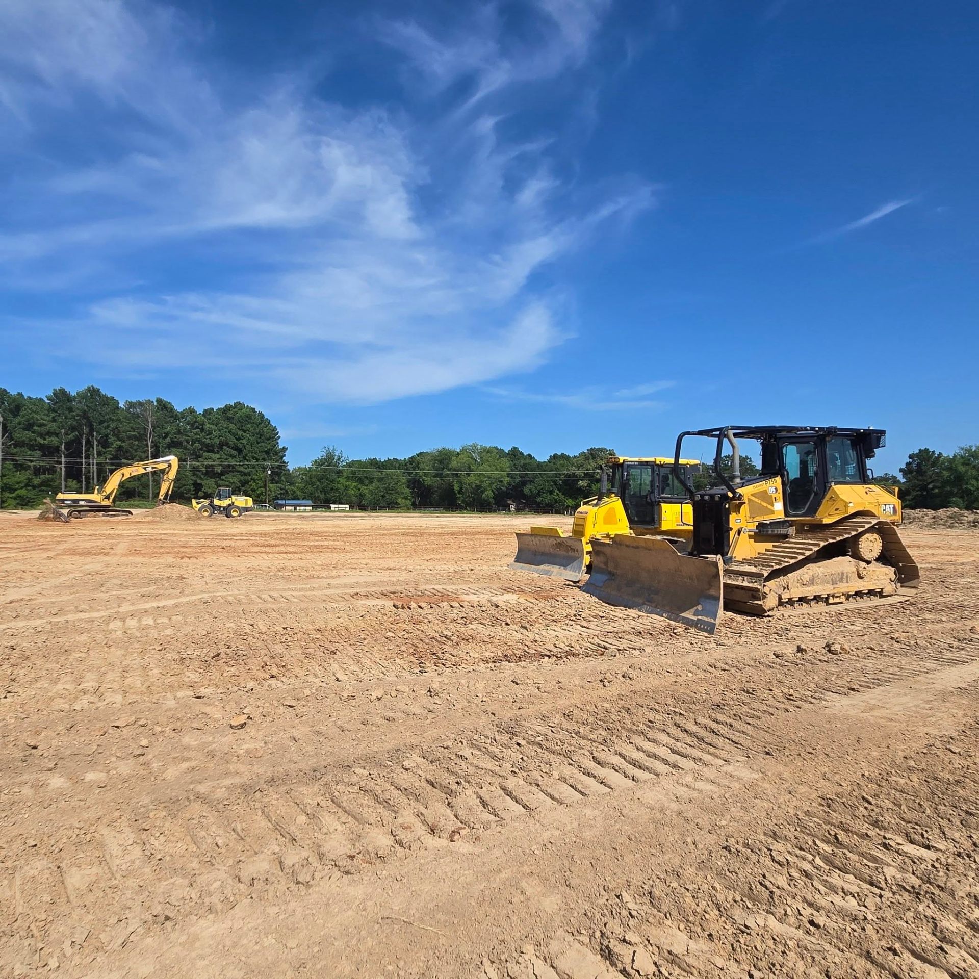 Bulldozer and excavator preparing building pad in Yantis Texas